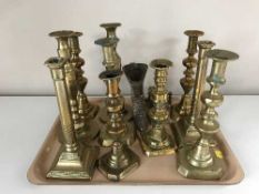 A tray of brass candlesticks,