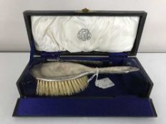 A silver brush in box