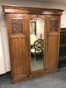 An Edwardian walnut mirror door wardrobe
