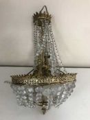 A mid twentieth century gilt brass light fitting with crystal drops
