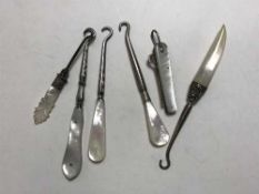 A Victorian silver folding button hook with mother of pearl grip,