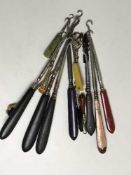 A collection of fifteen button hooks to include four with ebony handles, two Whitby jet examples,