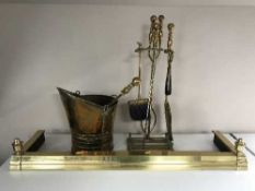 A brass adjustable fender together with brass coal bucket and fireside accessories