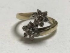 A 9ct gold diamond double cluster ring, approximately 0.5ct.