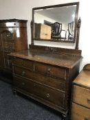 An oak four drawer dressing chest