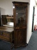 A mahogany corner display cabinet