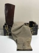 A box of early 20th century brown leather boots with gaters and a pair of vintage trousers