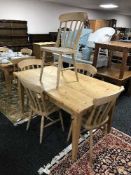 A large rectangular pine pub table and five pine chairs