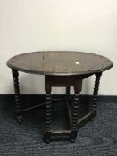 An Edwardian oak gate leg table