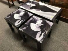 A contemporary coffee table and pair of matching lamp tables