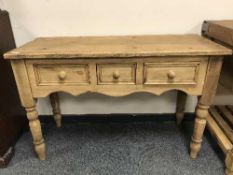 A reclaimed pine three drawer side table