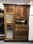An Edwardian oak compactum wardrobe