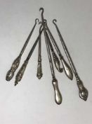 Seven Art Nouveau silver handled button hooks