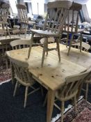 A rectangular pine pub table and four pine chairs