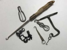 A Victorian coachman's button hook, two French folding button hooks, a deer's foor button hook,