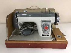 A Jones electrical sewing machine in case