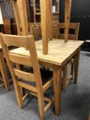 A square oak table and pair of ladder back chairs