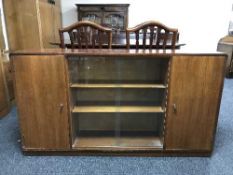A mahogany sliding door bookcase