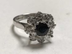 An 18ct white gold diamond and sapphire cluster ring
