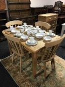A rectangular pine pub table and four pine chairs