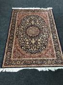 A Keshan fringed rug with silk pile on blue