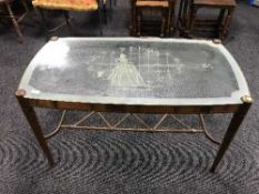 A glass topped walnut coffee table