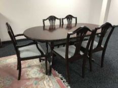A reproduction dining table and six chairs