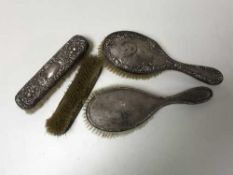 Four silver backed brushes