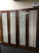 A continental mahogany four door glazed wardrobe