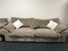 A pair of three seater settees, circular footstool,