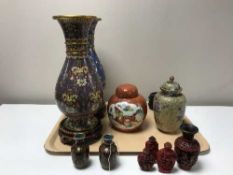 A pair of cliosonne vases, ginger jar, wooden stands,