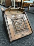 An Edwardian oak coal receiver