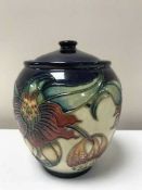 A Moorcroft ginger jar decorated with tube lined flowers