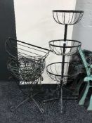 A metal garden three tier stand with hanging baskets