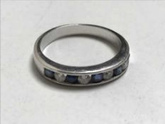 An 18ct white gold diamond and sapphire half eternity ring