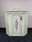 A contemporary painted corner cabinet with fruit decoration