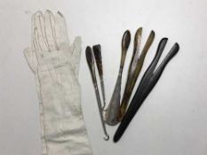 A pair of Victorian lady's calf skin leather gloves, two pairs of glove stretchers,