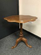A mahogany tripod table with shaped top