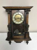 An Edwardian wall clock with enamelled dial