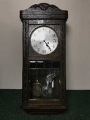 An Edwardian oak wall clock