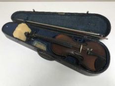 A violin and bow in wooden coffin case