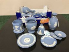 A collection of twenty one pieces of Wedgwood blue and white Jasperware comprising three vases,