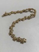 An 18ct gold floral diamond bracelet, 17.6g, approximately 3ct.