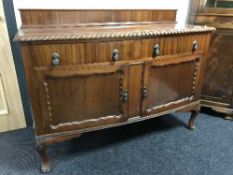 A mahogany Queen Anne style sideboard