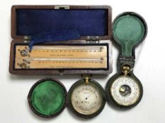 Two pocket compensated barometers, in original cases,