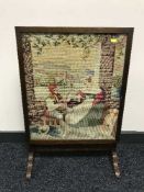A tapestry fire screen and small folding table