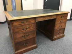 An Edwardian oak partner's desk with tooled leather top