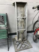 A galvanized metal trough and parasol stand