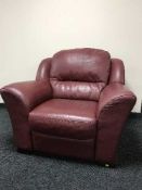 A burgandy leather reclining armchair