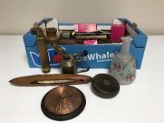 A box of ornaments, books, brass blow torch,
